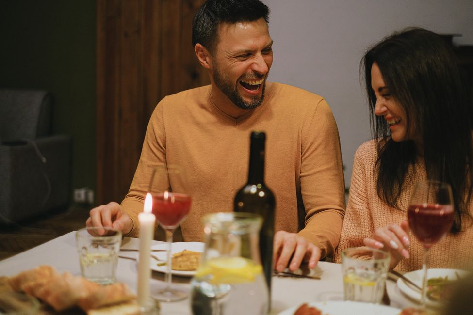 couple laughing at table