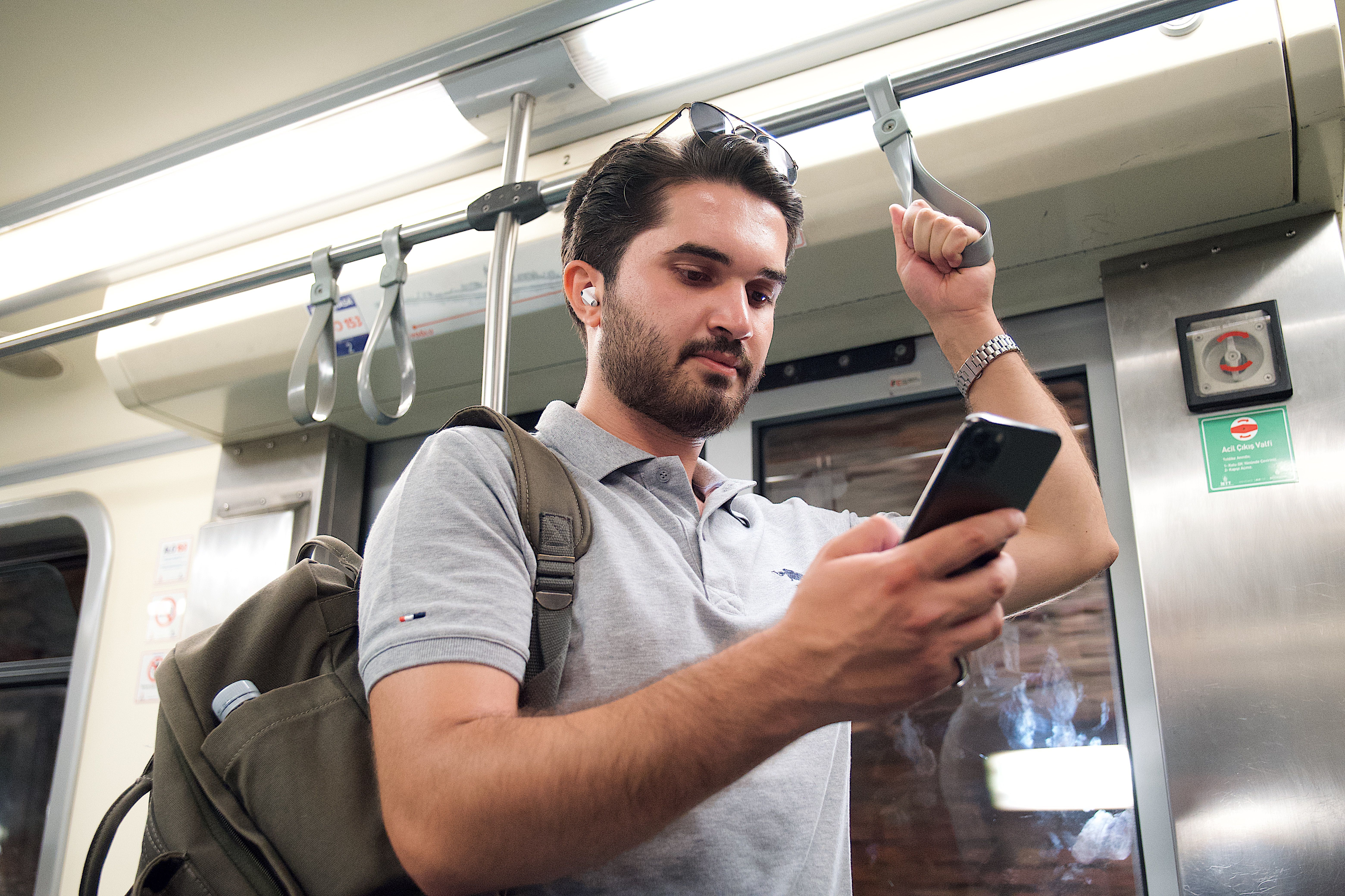 commuter wearing earbuds on train