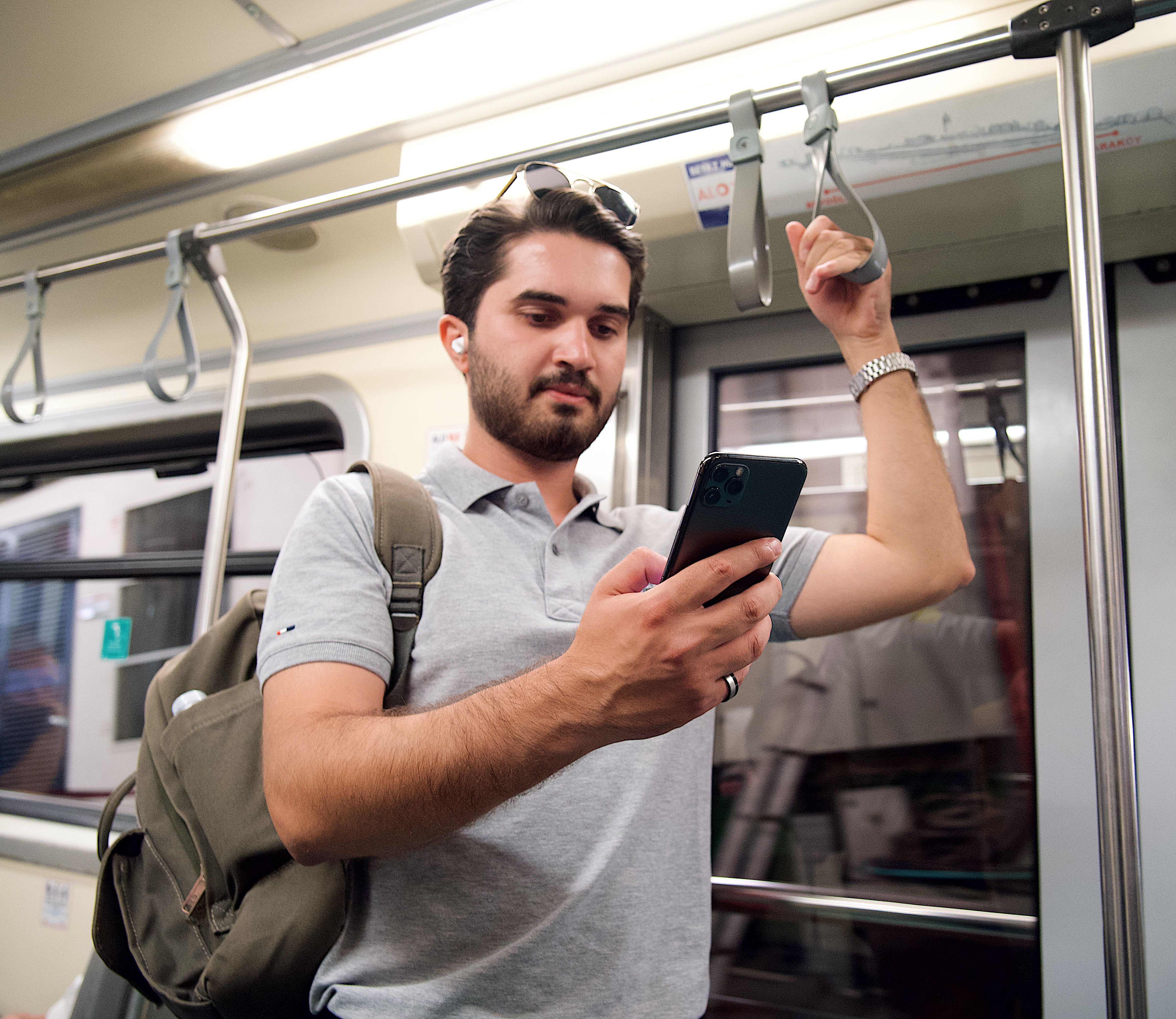 commuter on train with earbuds