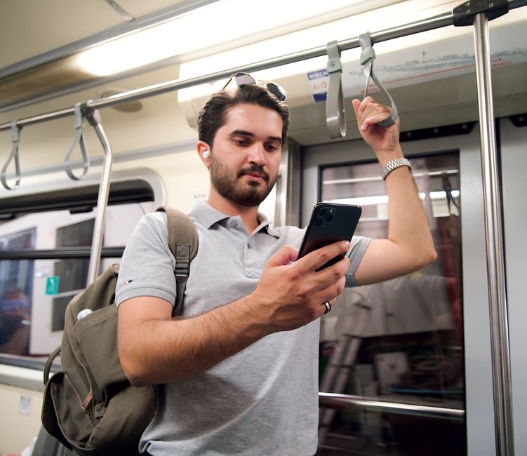 commuter on train with earbuds