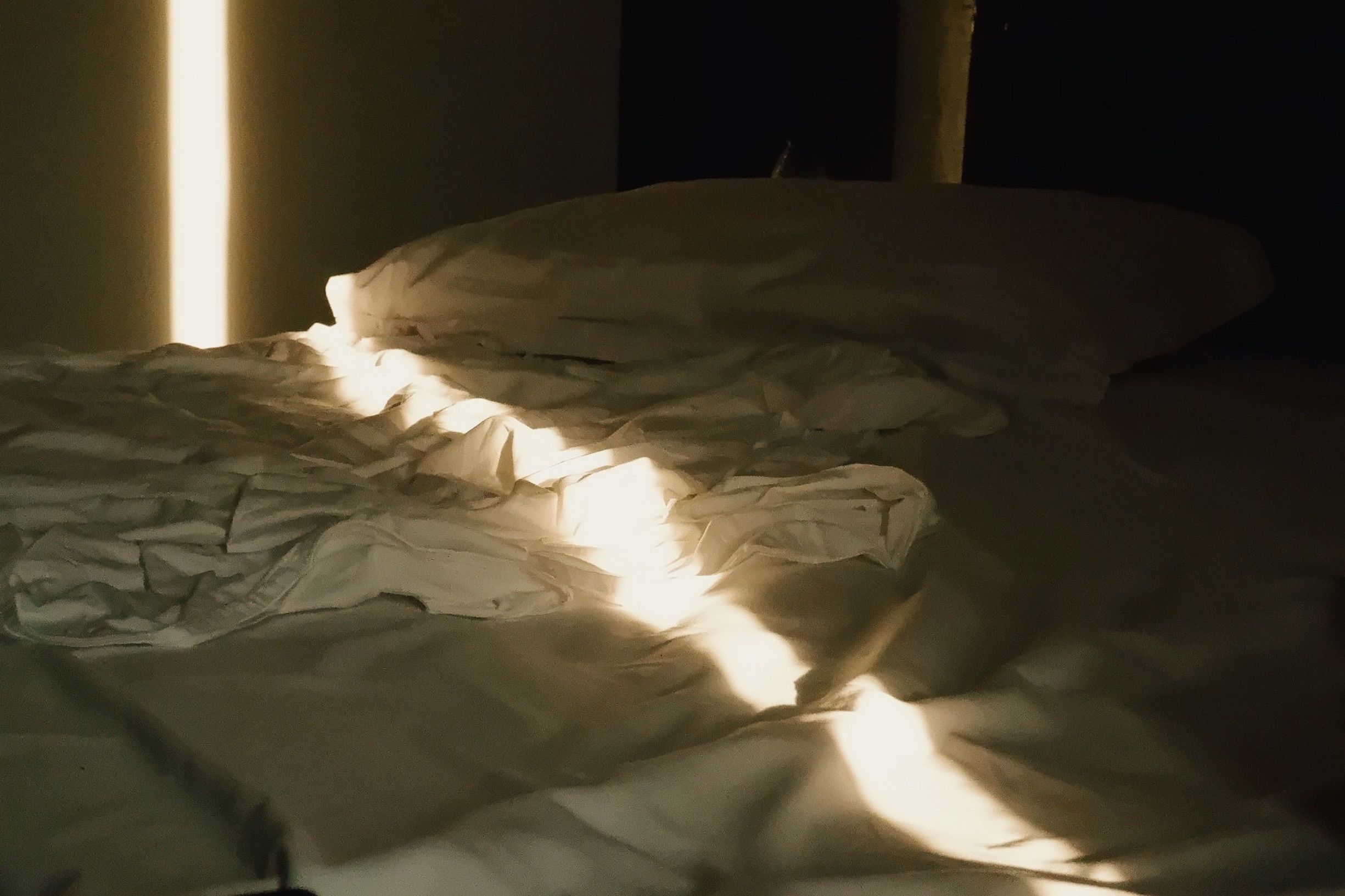 empty bed unmade sheets dawn