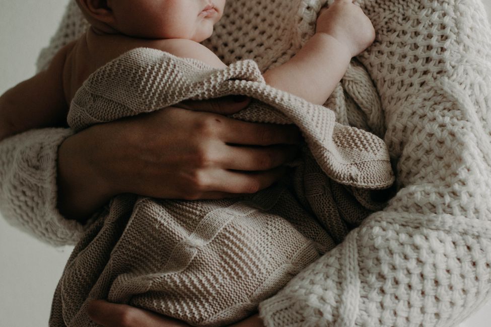 mother holding infant close