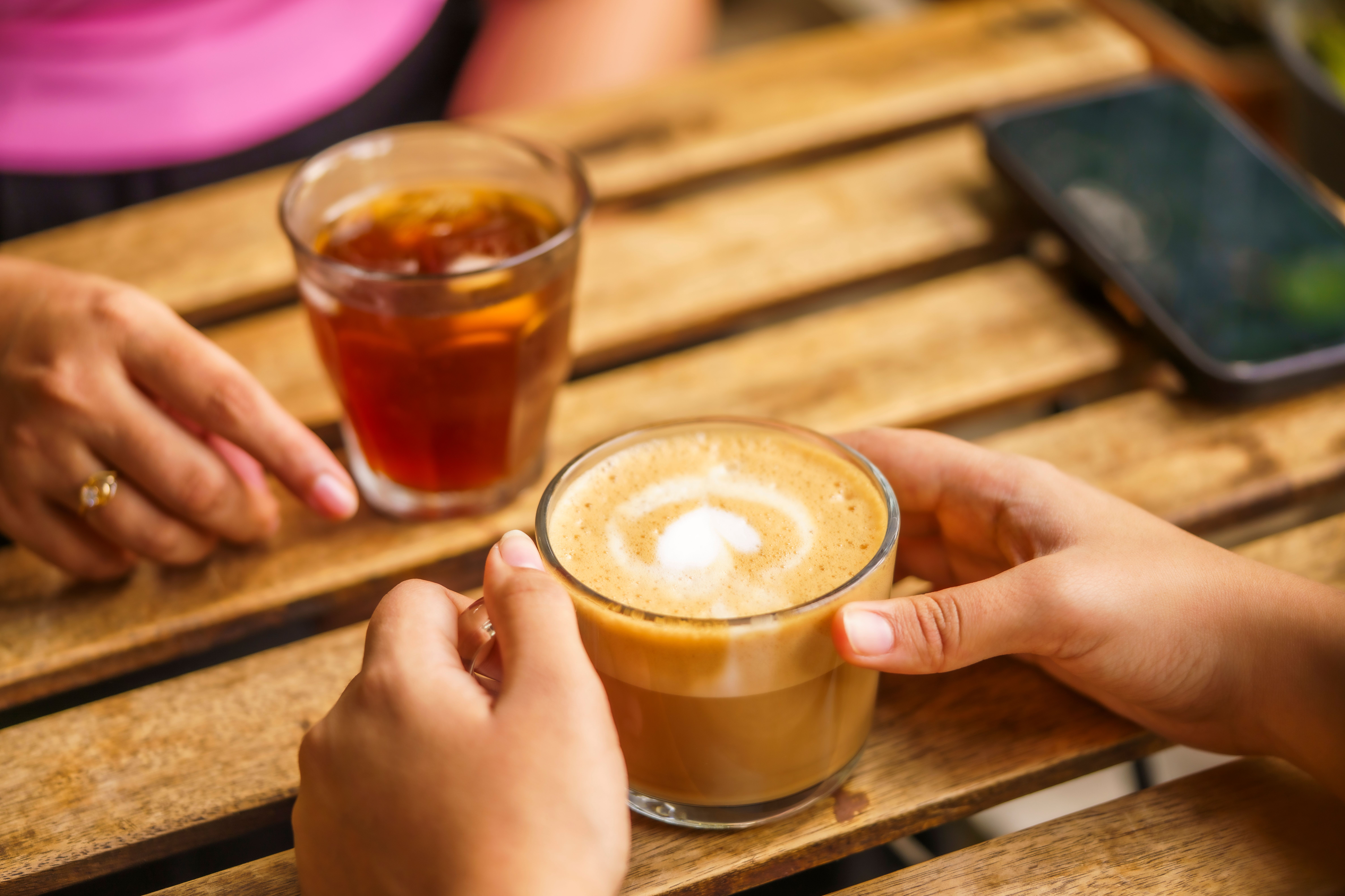 hands holding warm drinks