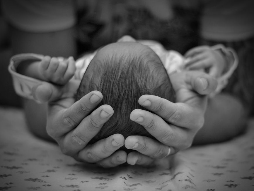 gentle hands holding head