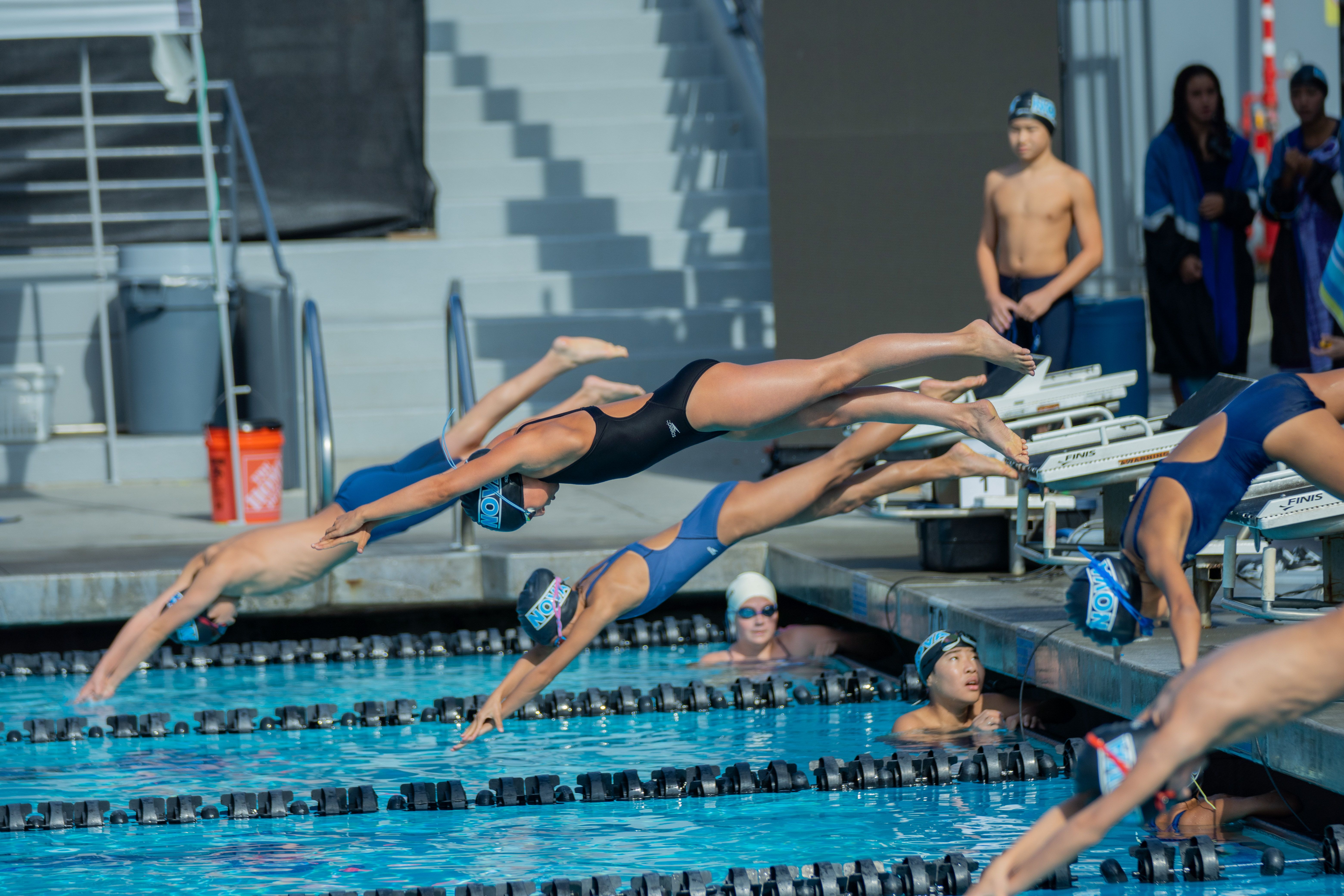 swimmers in outdoor pool