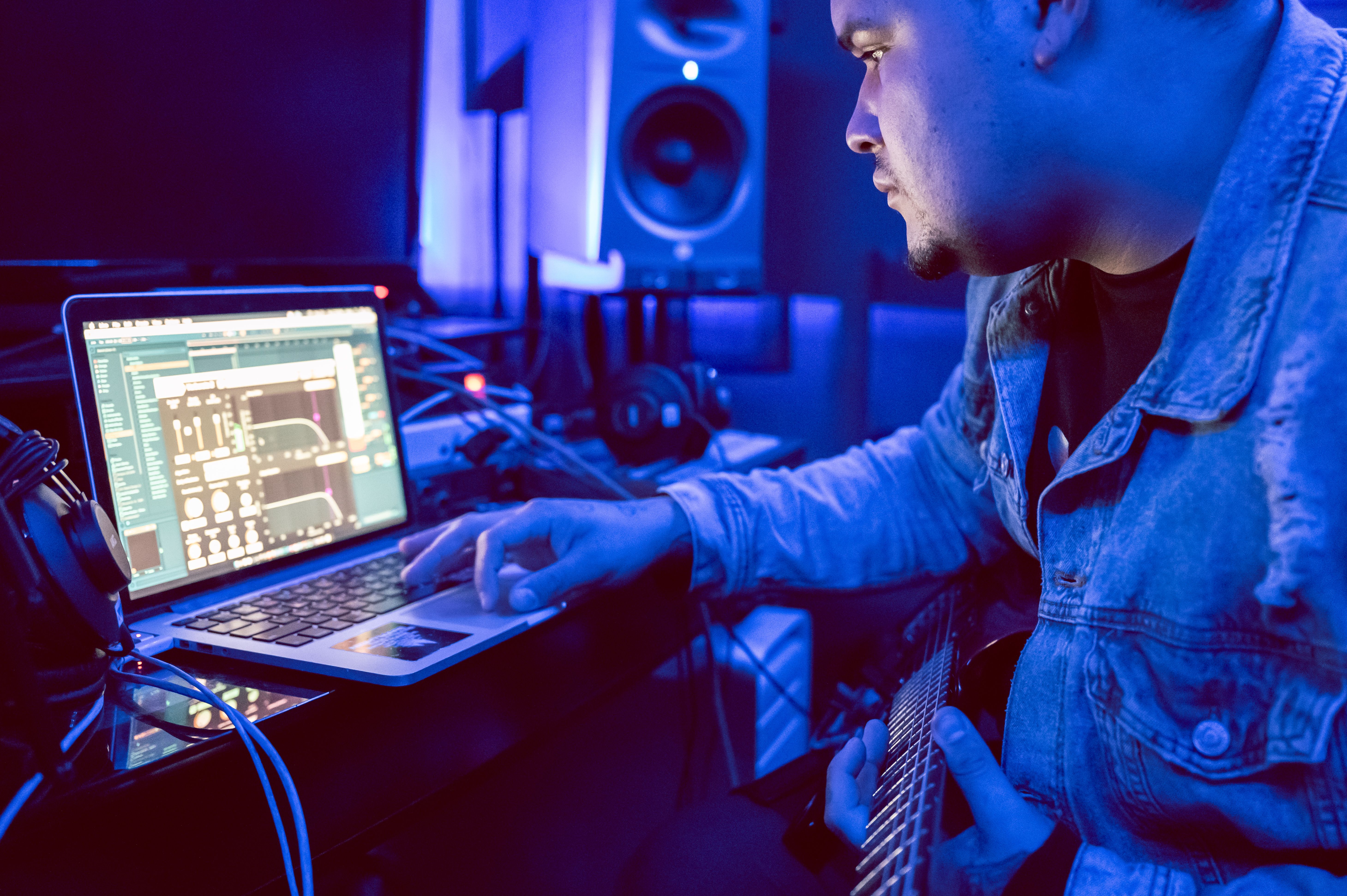Person editing audio on laptop
