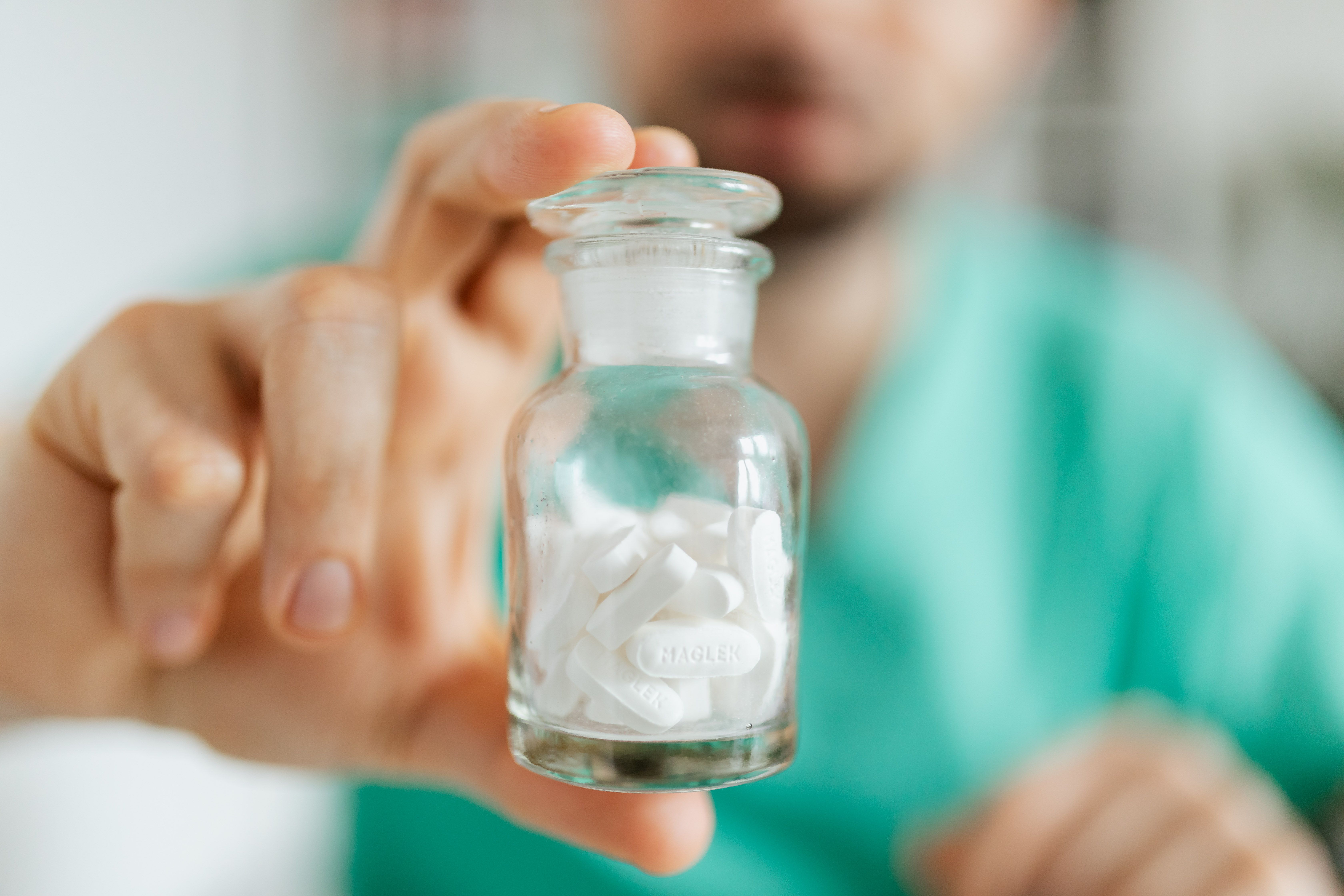 person holding medication bottle