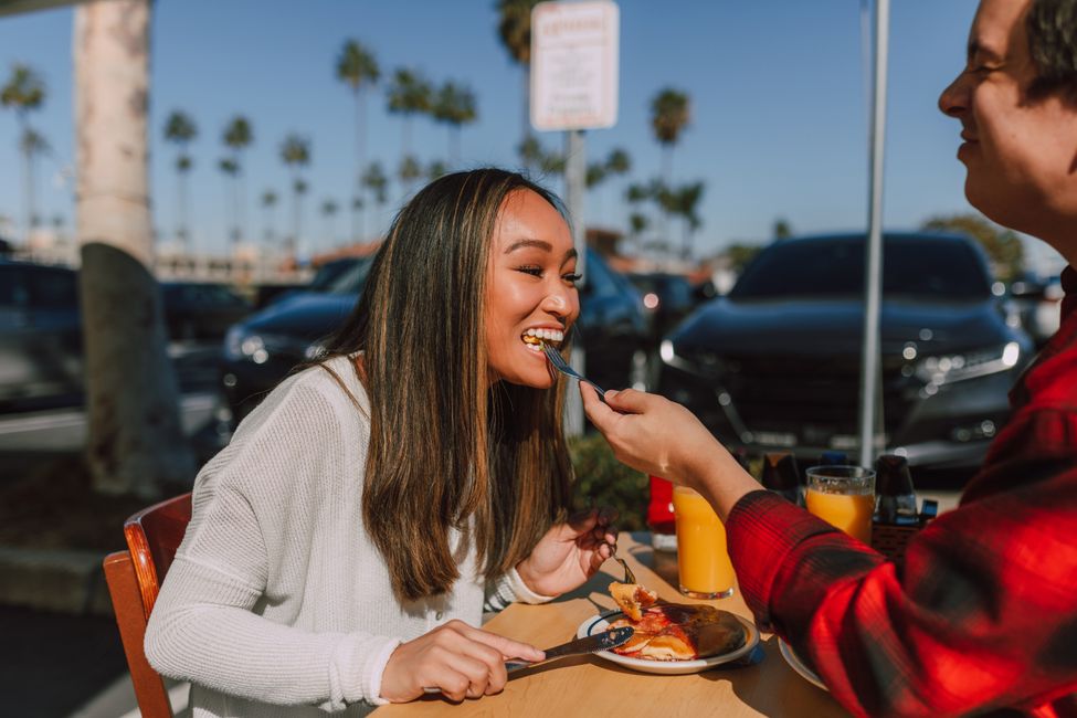 woman eating breakfast sunlight