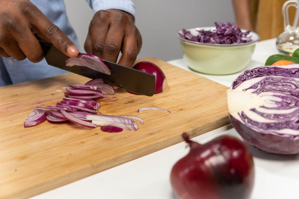 person chopping fresh vegetables