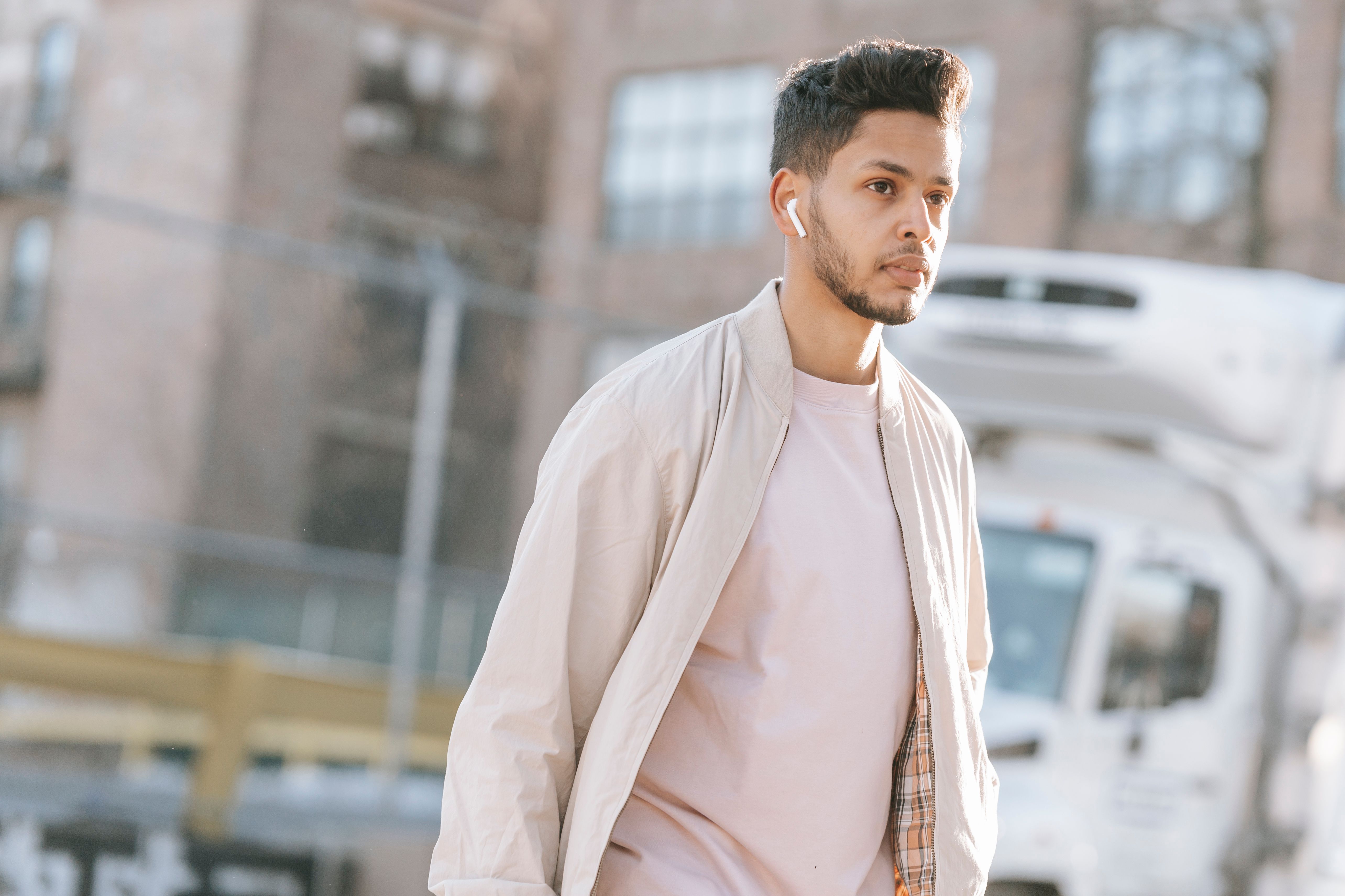 person walking listening earbuds