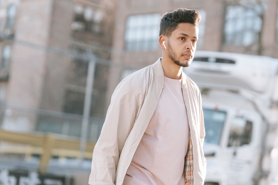person walking listening earbuds