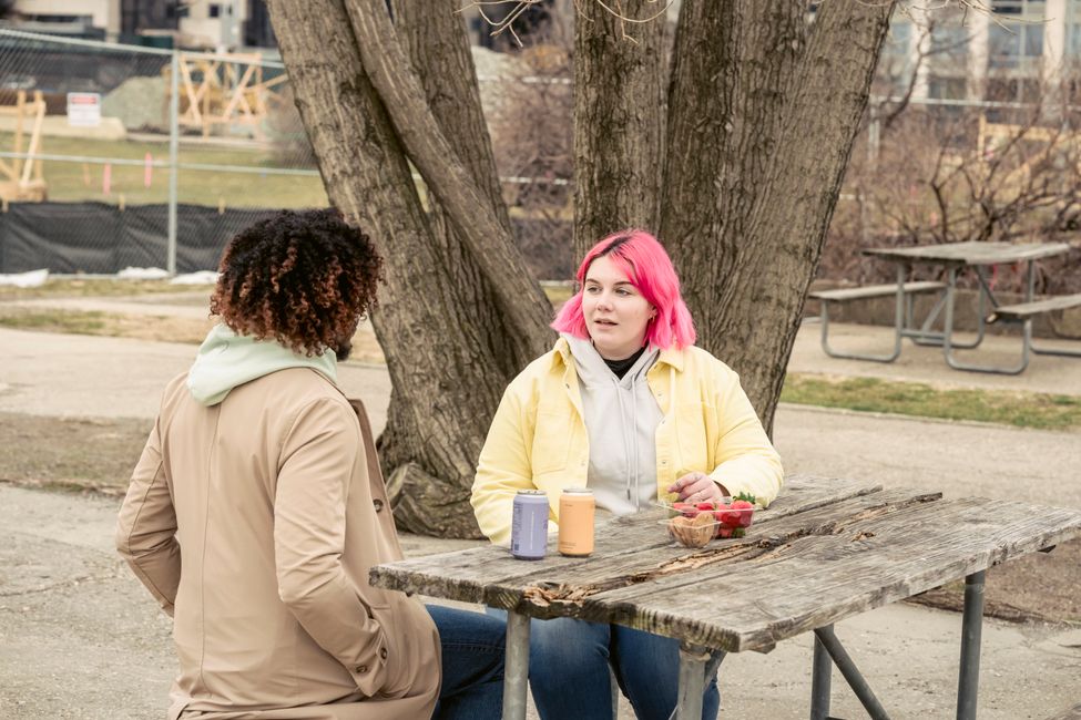 two people talking outdoors