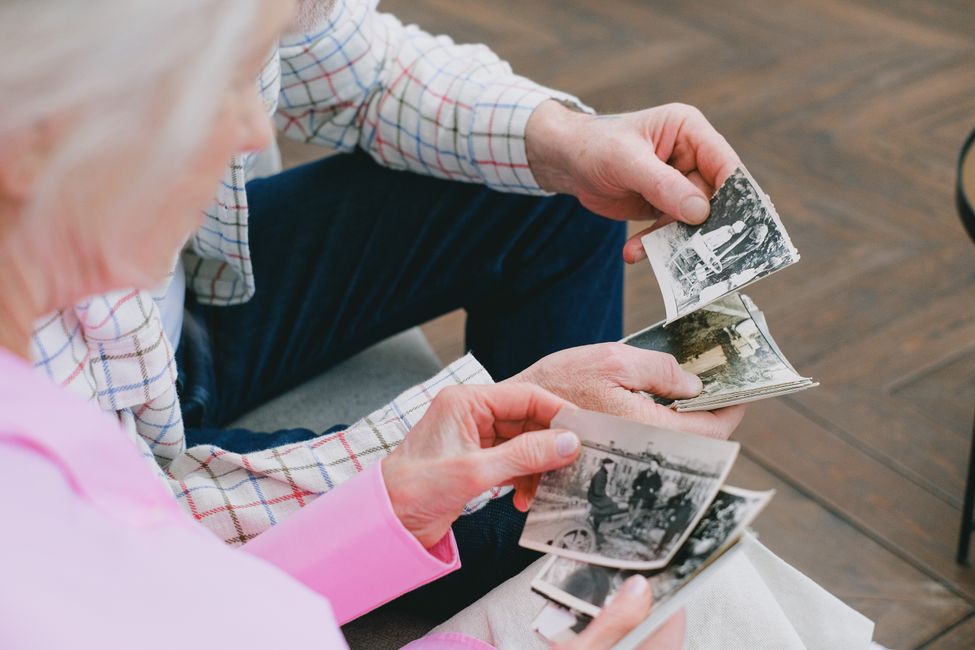 elderly hands holding photographs