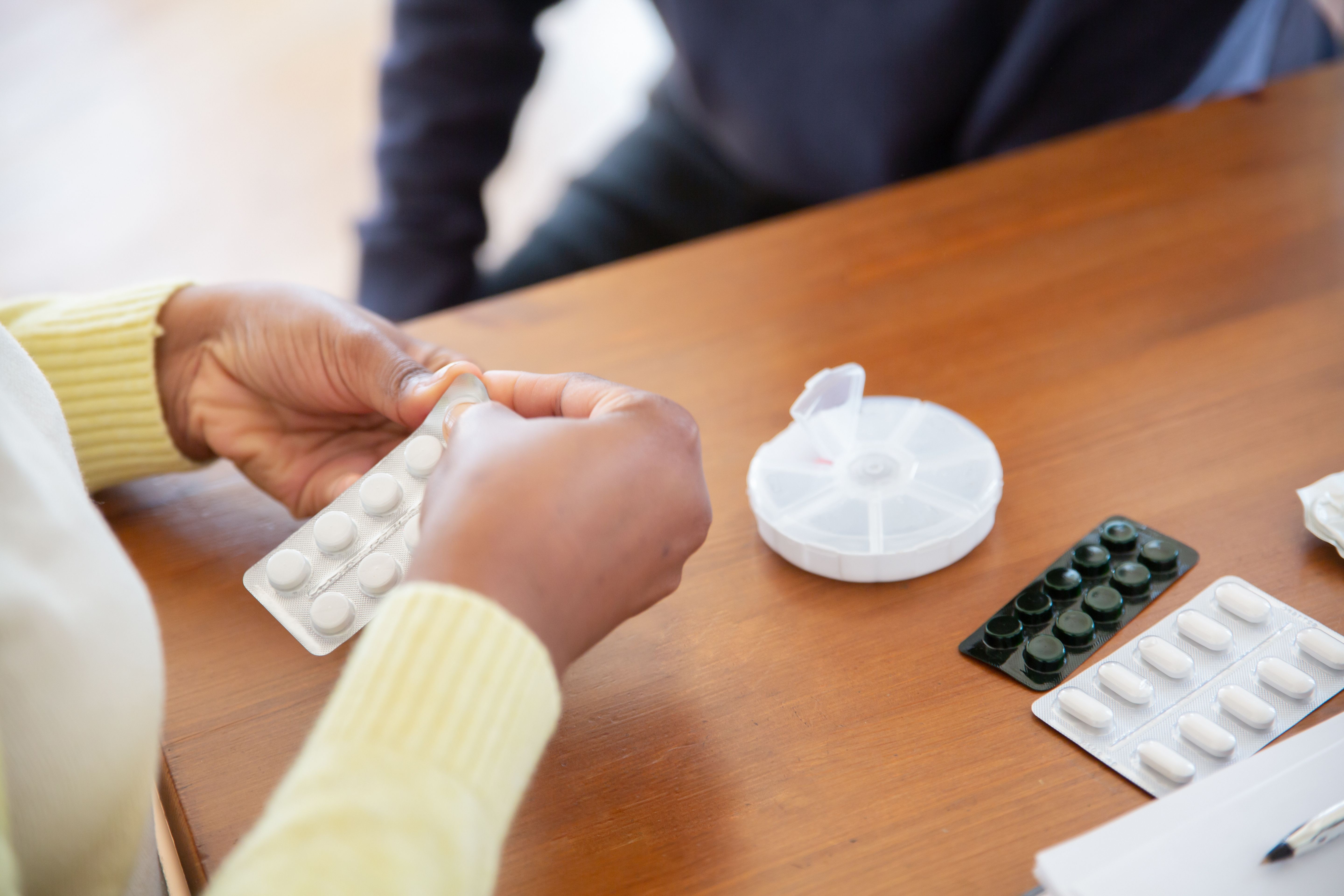 elderly hands holding medication