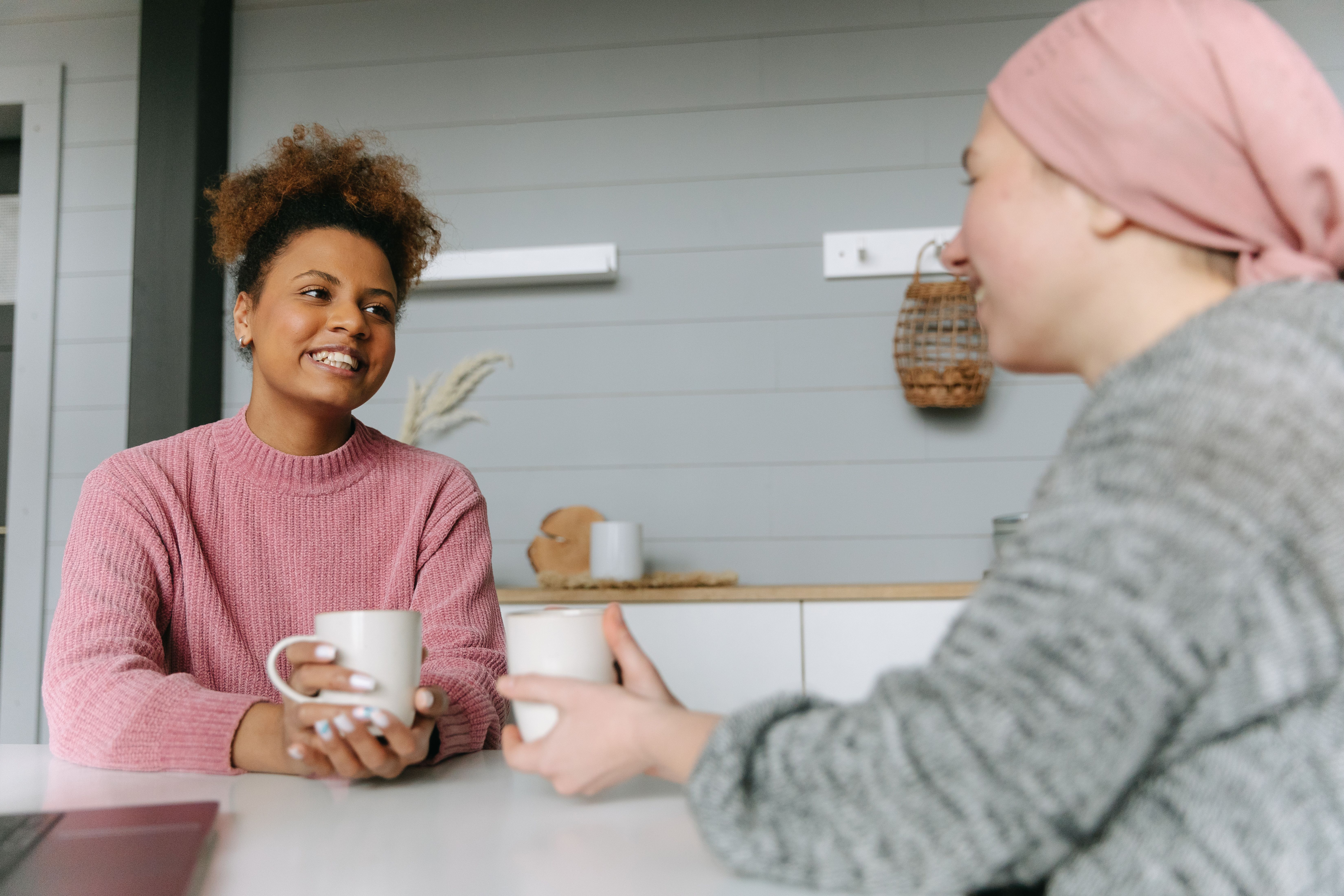 two women talking over coffee