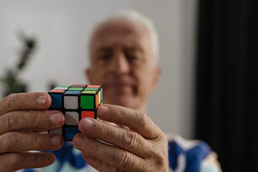 elderly hands holding puzzle