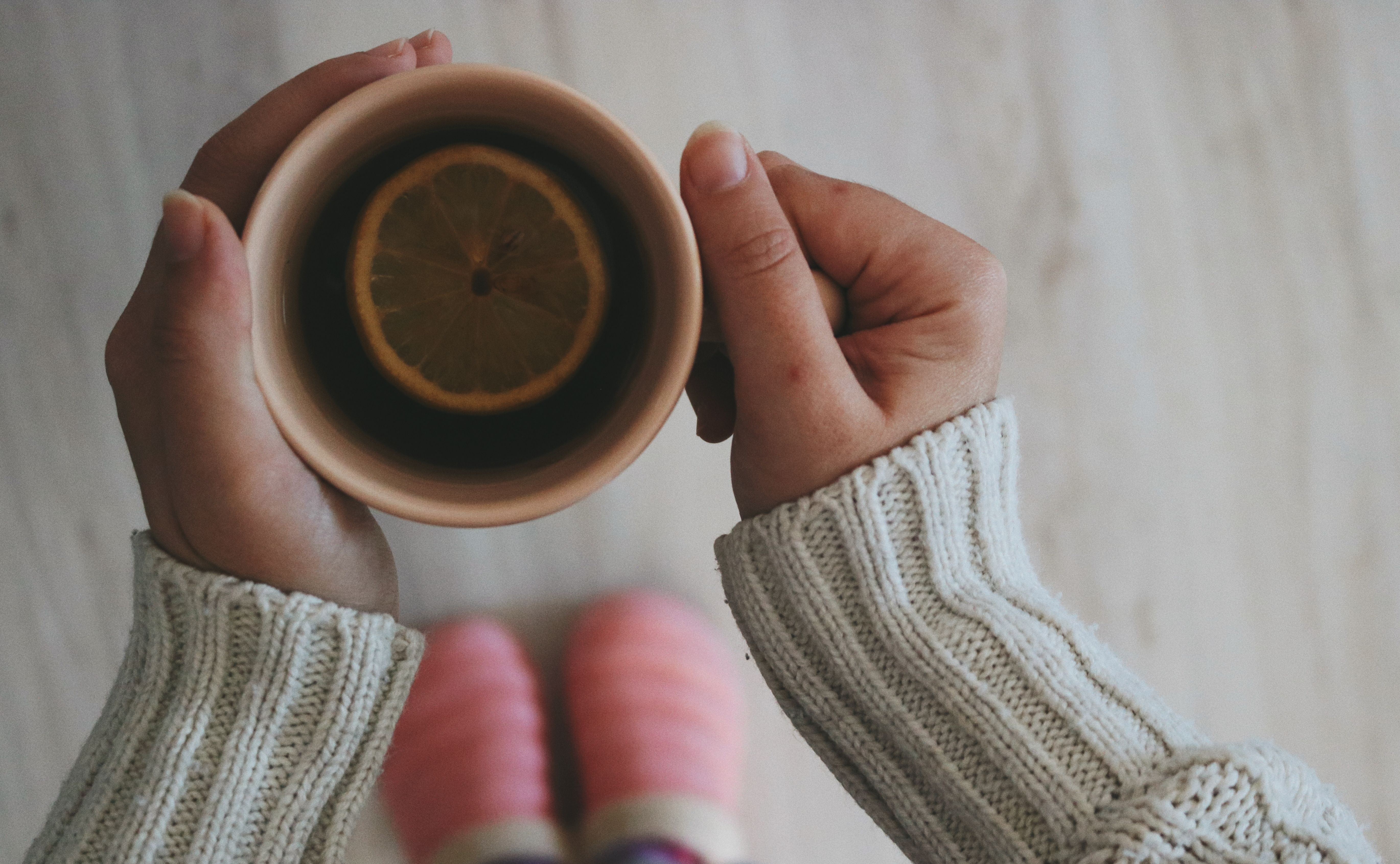 hands holding warm tea cup
