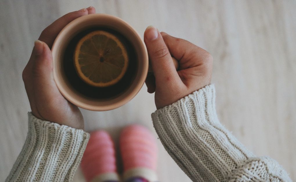 hands holding warm tea cup